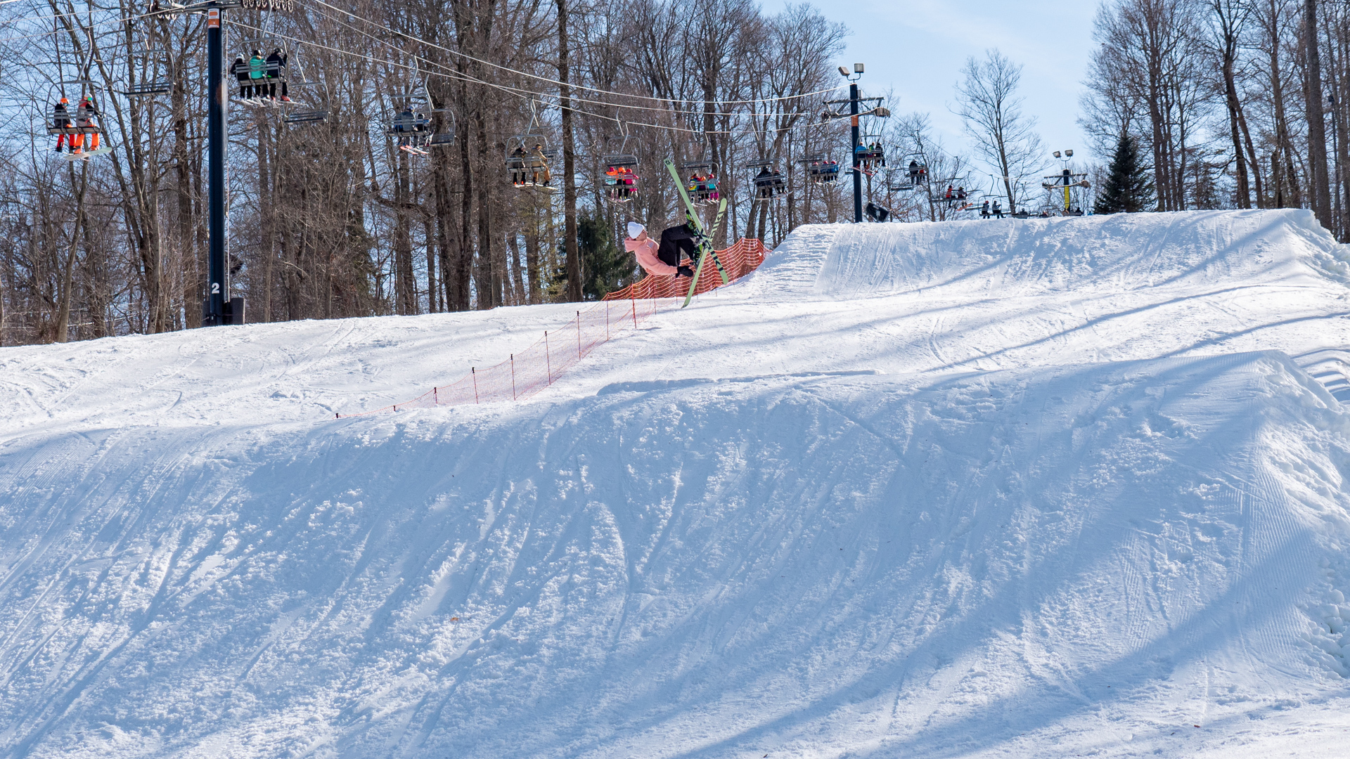 Skier doing a trick off Rustler Jump Line