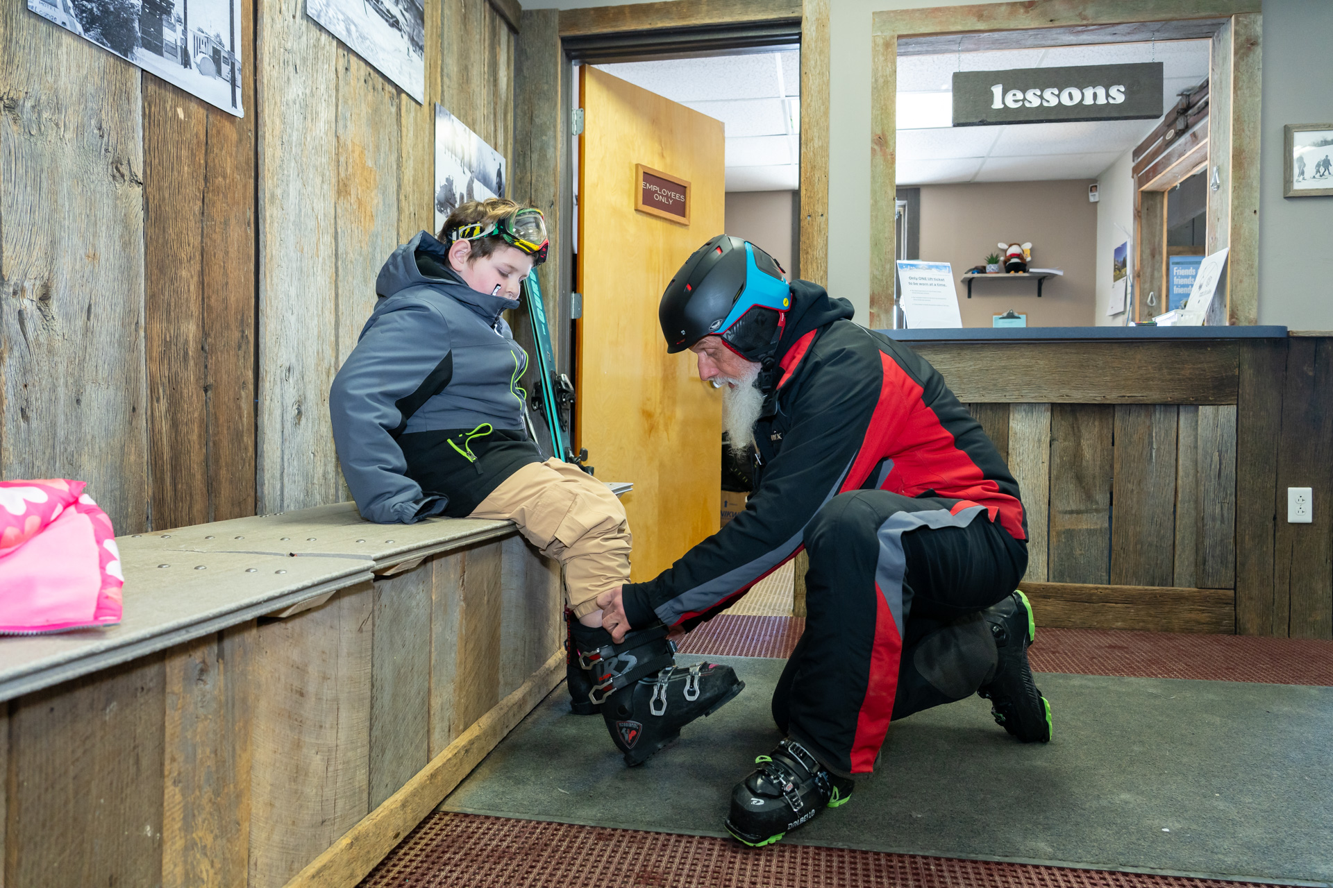 Ski Instructor helping Guest with Boot Fitting in Rental Center - Winter Employment at Snow Trails in Mansfield, Ohio