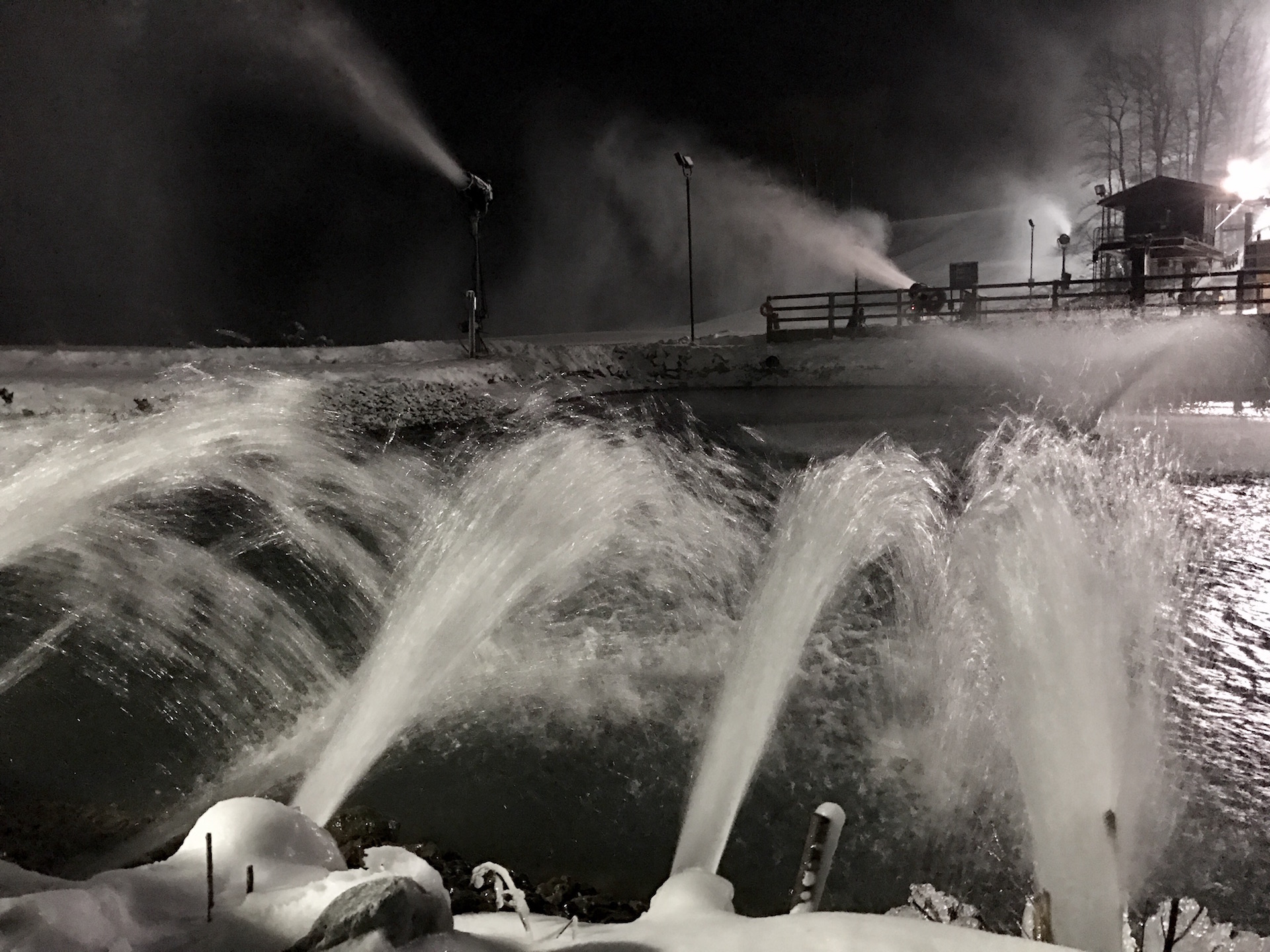 Pumping water for snowmaking into holding pond with snow guns in action on Tubing Park at Snow Trails in Mansfield, Ohio